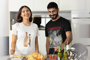 Attractive young couple smiling and laughing while preparing snacks in their kitchen wearing Vino Tees T shirts.